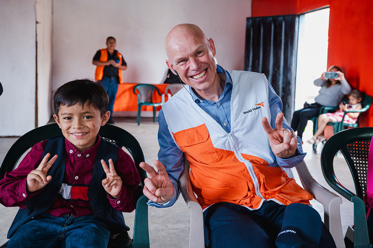 Andrew Morley with child in one of World Vision's programme areas